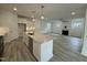 Open concept kitchen and living area with large island and hardwood floors at 231 Village Walk Dr, Clayton, NC 27527