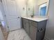Bathroom with gray vanity and marble-look tile flooring at 154 Swain St, Clayton, NC 27527