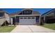 Two-story home with gray siding and a white garage door at 154 Swain St, Clayton, NC 27527
