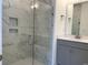 Bathroom with gray vanity, walk-in shower, and marble tile at 154 Swain St, Clayton, NC 27527