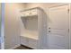 White built-in coat closet with bench and cabinets at 2744 Lacy Holt Rd, Graham, NC 27253