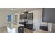 Modern kitchen with gray cabinets, quartz countertops, and stainless steel appliances at 2728 Princess Tree Dr, Raleigh, NC 27616