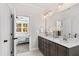 Modern bathroom with double vanity, quartz countertops and a view of a bedroom at 1319 Wiley Rd, Spring Hope, NC 27882