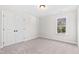 Bright bedroom with carpet flooring, double door closet, and a window with a view at 1319 Wiley Rd, Spring Hope, NC 27882