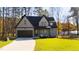 Two-story craftsman home with gray siding, dark brown accents, and a landscaped lawn at 1319 Wiley Rd, Spring Hope, NC 27882