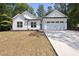 White farmhouse style home with two car garage at 242 Sequoia Dr, Louisburg, NC 27549