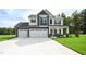 Two-story home with three-car garage and stone accents at 196 Abingdon Farms Dr, Selma, NC 27576