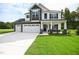 Two-story home with three-car garage and stone accents at 196 Abingdon Farms Dr, Selma, NC 27576