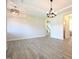 Spacious dining room with hardwood floors, chandelier, and access to stairs at 196 Abingdon Farms Dr, Selma, NC 27576