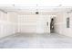 Unfinished garage with concrete floor and access door at 81 Hank Way, Angier, NC 27501