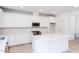 Modern kitchen with white cabinets, quartz island and stainless steel appliances at 81 Hank Way, Angier, NC 27501