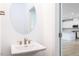 Modern bathroom with an oval mirror and pedestal sink at 81 Hank Way, Angier, NC 27501