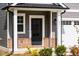 Front door entrance with gray siding and brick accents at 81 Hank Way, Angier, NC 27501