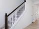 Staircase with dark brown handrail and carpeted steps at 81 Hank Way, Angier, NC 27501