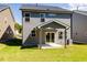 Two-story home with gray siding, covered patio, and grassy yard at 81 Hank Way, Angier, NC 27501