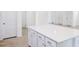 White kitchen island with quartz countertop and drawers at 81 Hank Way, Angier, NC 27501