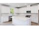 Modern kitchen with white cabinets, quartz island and stainless steel appliances at 81 Hank Way, Angier, NC 27501