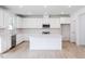 Modern kitchen with white cabinets, quartz island and stainless steel appliances at 81 Hank Way, Angier, NC 27501