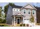 Two-story house with gray siding, white garage door, and landscaping at 81 Hank Way, Angier, NC 27501
