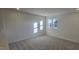 Well-lit bedroom with carpet flooring and two windows at 466 Saint Clair Dr, Fuquay Varina, NC 27526