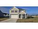 Two-story home with gray siding, white garage door, and landscaping at 466 Saint Clair Dr, Fuquay Varina, NC 27526