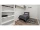 Small bedroom with built-in shelves and a twin bed at 5121 Watkinsdale Ave, Raleigh, NC 27613