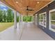 Spacious covered patio with ceiling fan and wooded views at 5121 Watkinsdale Ave, Raleigh, NC 27613