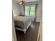 Bedroom with a floral-patterned bed and dark brown flooring at 7253 Hunt Valley Trl, Wendell, NC 27591