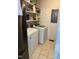 Well-lit laundry room, featuring washer, dryer, and ample shelving at 7253 Hunt Valley Trl, Wendell, NC 27591