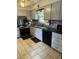 Kitchen with gray cabinets, granite countertops, and stainless steel appliances at 7253 Hunt Valley Trl, Wendell, NC 27591