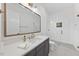 Modern bathroom with dark vanity, frameless shower, and white tile at 13541 Old Creedmoor Rd, Wake Forest, NC 27587