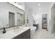 Elegant bathroom with soaking tub, double vanity, and marble tile at 13541 Old Creedmoor Rd, Wake Forest, NC 27587