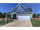 Charming craftsman style home with gray siding, white trim, and two-car garage at 3102 Castlerock Dr # 2, Burlington, NC 27215