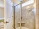 Glass-enclosed shower with tiled walls and a built-in seat at 3102 Castlerock Dr # 2, Burlington, NC 27215