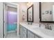 Bathroom with double vanity, large mirror, and shower at 6920 Will Let Ln, Wake Forest, NC 27587