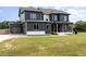 Two-story home with gray exterior, white trim, two-car garage, and green lawn at 6920 Will Let Ln, Wake Forest, NC 27587