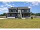 Two story home with dark siding, white accents, and a large yard at 6920 Will Let Ln, Wake Forest, NC 27587