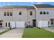 Rear view of townhouses with garage and lawn at 1431 Goldsboro Ave, Sanford, NC 27330