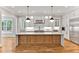 Modern kitchen with white cabinets, quartz countertops and a large island at 503 Damascus Church Rd, Chapel Hill, NC 27516