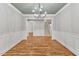 Elegant dining room with hardwood floors, wainscoting, and a chandelier at 503 Damascus Church Rd, Chapel Hill, NC 27516