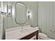 Powder room with a stylish vanity, updated fixtures and a large mirror at 503 Damascus Church Rd, Chapel Hill, NC 27516