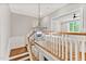 Elegant staircase with a chandelier and wooden railings at 503 Damascus Church Rd, Chapel Hill, NC 27516
