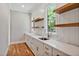 Butlers pantry with white cabinets, quartz countertops, and hardwood floors at 503 Damascus Church Rd, Chapel Hill, NC 27516