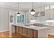 Modern kitchen with white cabinets, quartz countertops, and a large island at 503 Damascus Church Rd, Chapel Hill, NC 27516