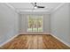 Spacious bedroom with hardwood floors and large windows offering views of the backyard at 503 Damascus Church Rd, Chapel Hill, NC 27516