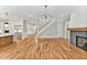 Open living space with hardwood floors, a fireplace, and kitchen views at 503 Damascus Church Rd, Chapel Hill, NC 27516