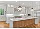 Modern kitchen with white cabinets, quartz countertops and a large island at 503 Damascus Church Rd, Chapel Hill, NC 27516