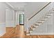 Elegant staircase with white railings and hardwood floors leading to the upper level at 503 Damascus Church Rd, Chapel Hill, NC 27516