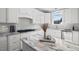 White kitchen cabinets, granite countertops, and a gas cooktop at 4566 Ashtons Way, Franklinton, NC 27525