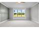 Bedroom with large window, accent wall, and carpet flooring at 4566 Ashtons Way, Franklinton, NC 27525